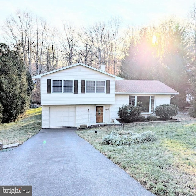 view of front of property with a yard and a garage