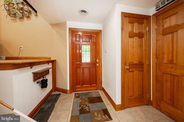 foyer entrance with light tile patterned floors