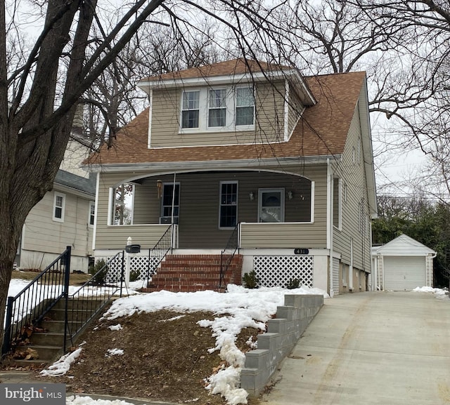 bungalow-style house featuring an outdoor structure, a garage, covered porch, and a shingled roof