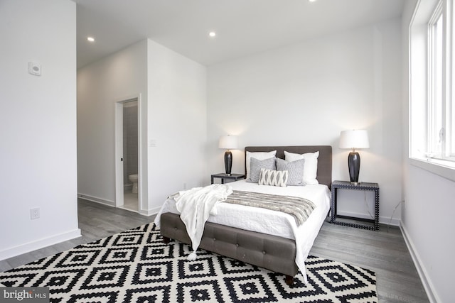 bedroom featuring wood-type flooring and connected bathroom