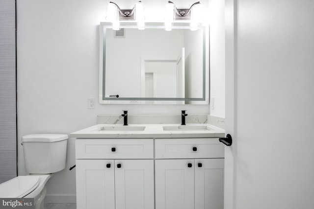 bathroom with toilet and vanity