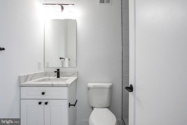 bathroom featuring toilet and vanity