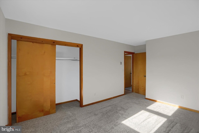 unfurnished bedroom featuring a closet and light carpet