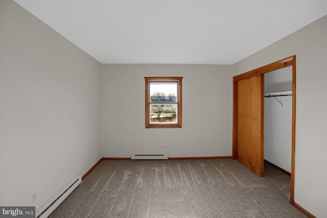 unfurnished bedroom with carpet flooring, a closet, and baseboard heating