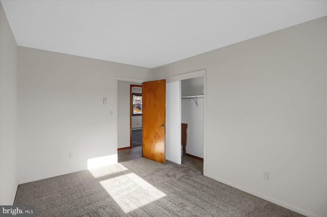 unfurnished bedroom with carpet floors and a closet