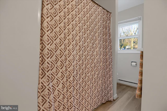 bathroom featuring hardwood / wood-style flooring and a baseboard radiator