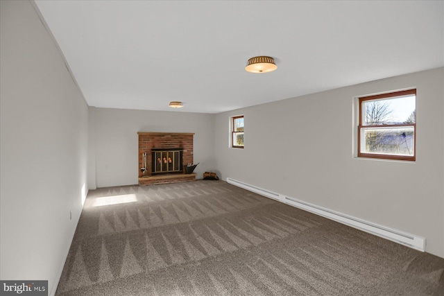 unfurnished living room with a brick fireplace, carpet flooring, and a baseboard heating unit