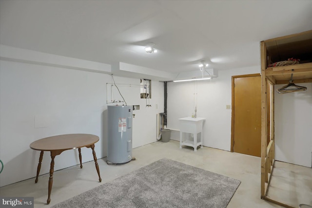 basement featuring sink and electric water heater