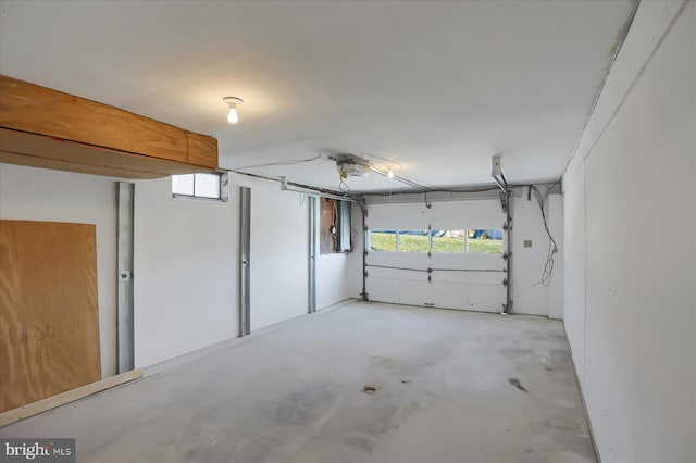 garage featuring a garage door opener and electric panel