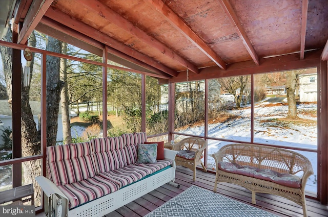 unfurnished sunroom featuring lofted ceiling and plenty of natural light