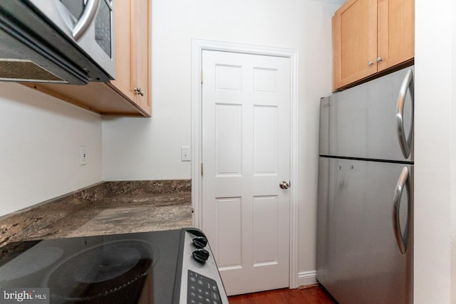 laundry area with dark hardwood / wood-style floors