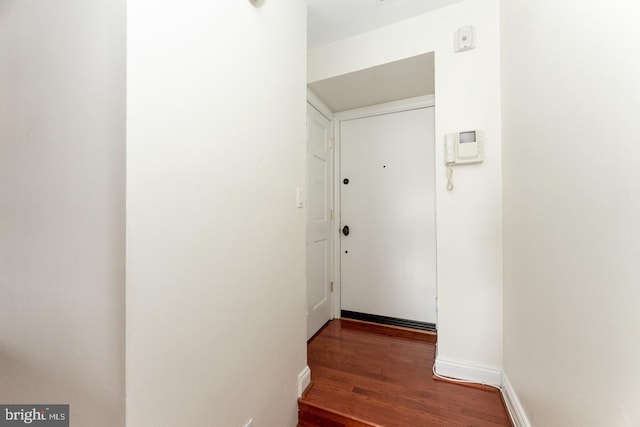 hall with dark wood-type flooring