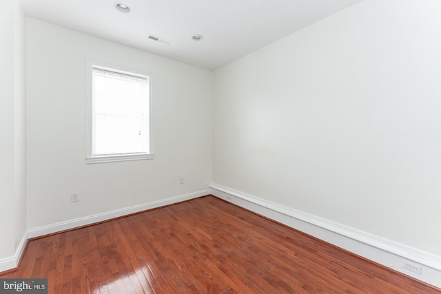 spare room with hardwood / wood-style flooring