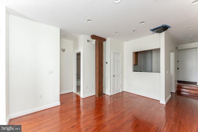 unfurnished living room featuring wood-type flooring