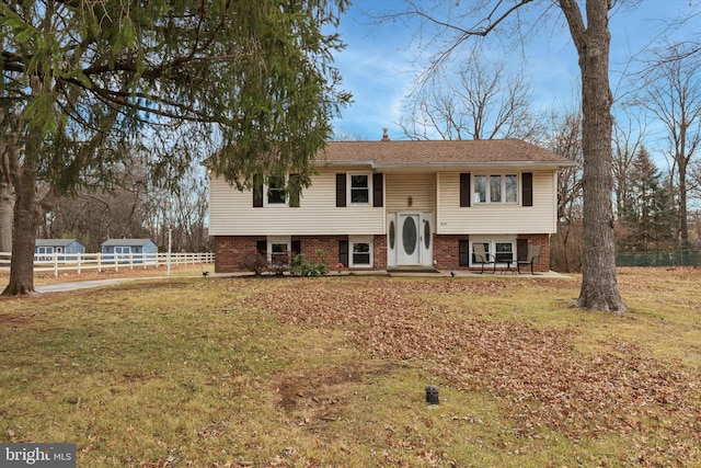 raised ranch featuring a front yard