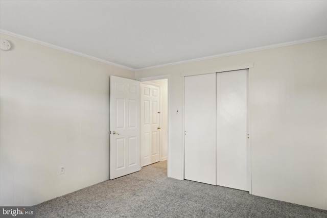 unfurnished bedroom featuring a closet, light carpet, and ornamental molding