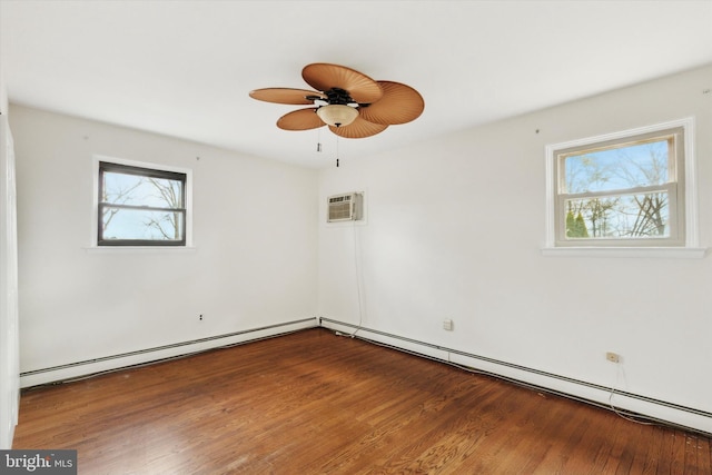 spare room with ceiling fan, a wall mounted AC, a baseboard radiator, and wood-type flooring