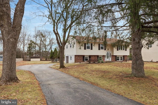 split foyer home with a front lawn