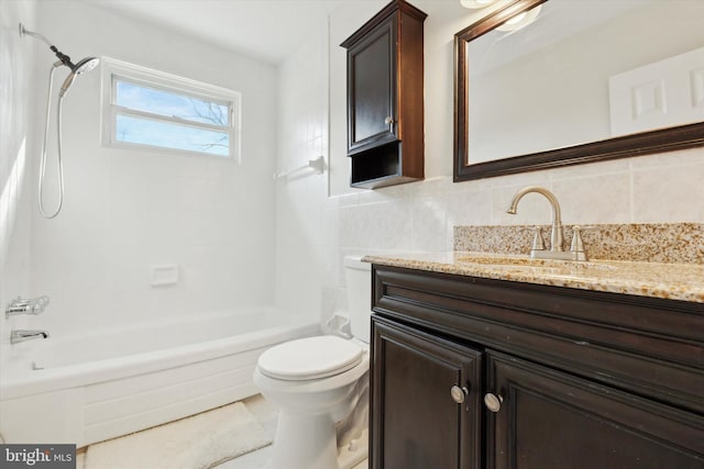 full bathroom with toilet, tiled shower / bath, tasteful backsplash, and vanity