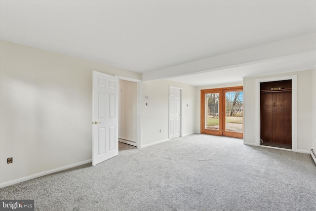 carpeted spare room with a baseboard radiator