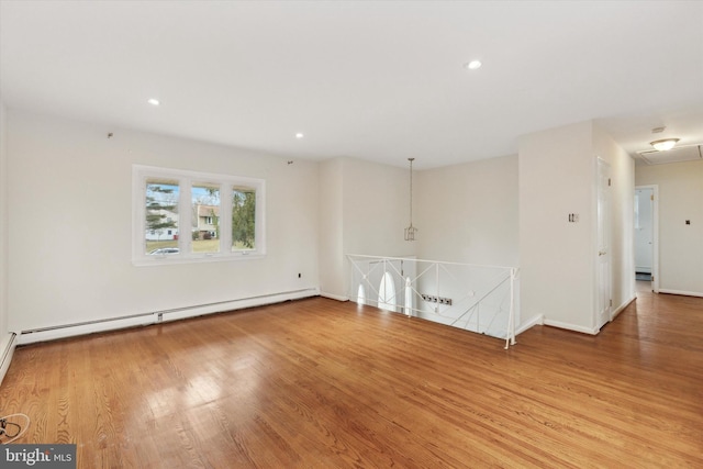 unfurnished living room featuring light wood-type flooring and a baseboard radiator