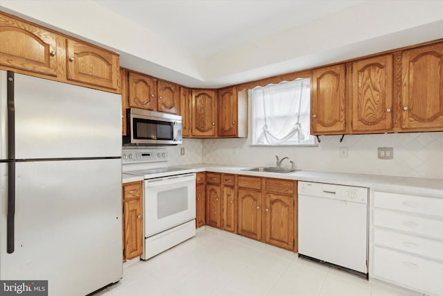 kitchen with appliances with stainless steel finishes, backsplash, and sink