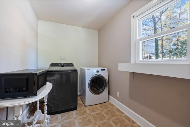 clothes washing area featuring washer and dryer