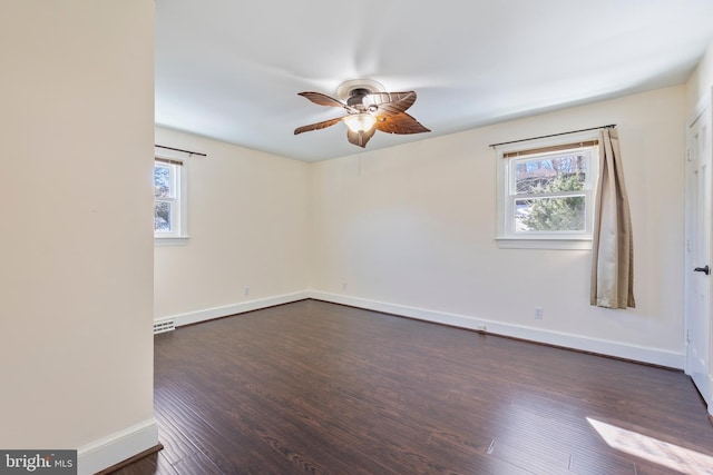 empty room with dark hardwood / wood-style floors and ceiling fan