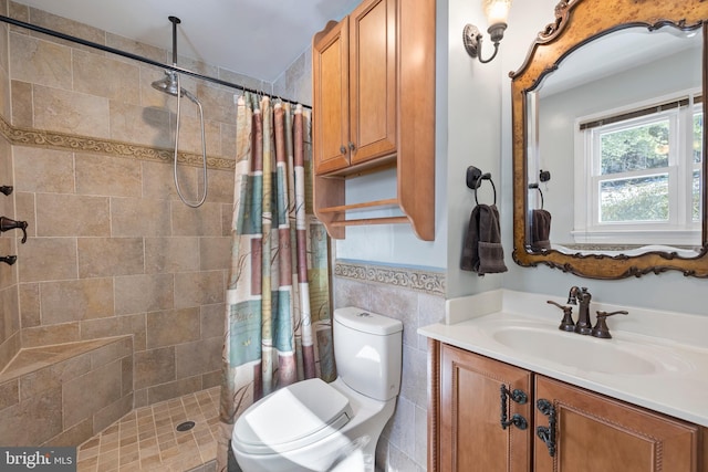 bathroom with vanity, toilet, a shower with shower curtain, and tile walls