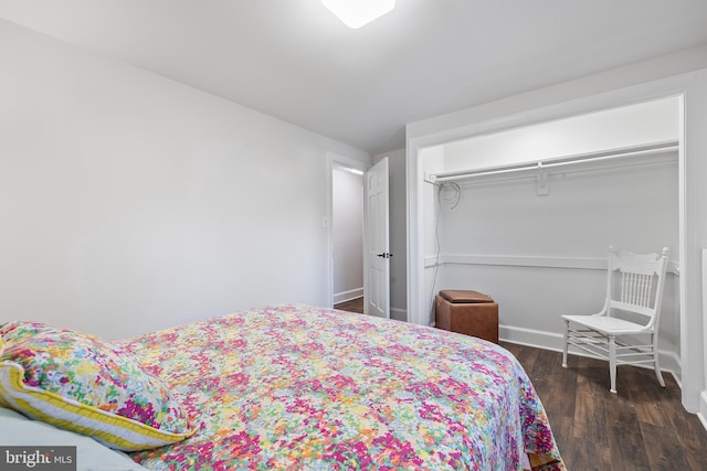 bedroom with a closet and dark hardwood / wood-style floors