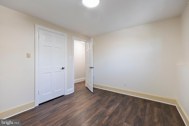 unfurnished bedroom featuring dark hardwood / wood-style flooring