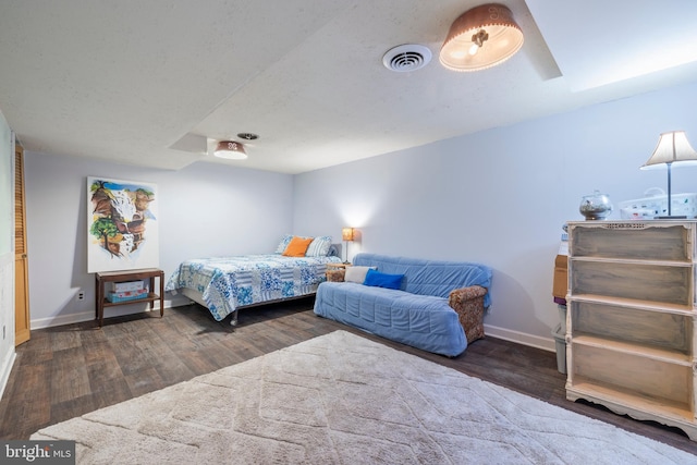 bedroom with dark hardwood / wood-style floors