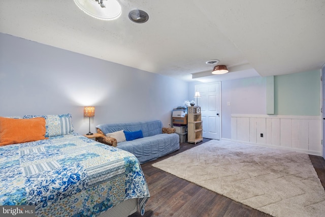 bedroom with dark hardwood / wood-style flooring