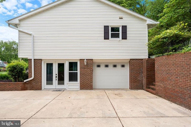 115 Woodland Rd, Fredericksburg, VA 22401 - rear view of house with a garage, brick siding, and driveway