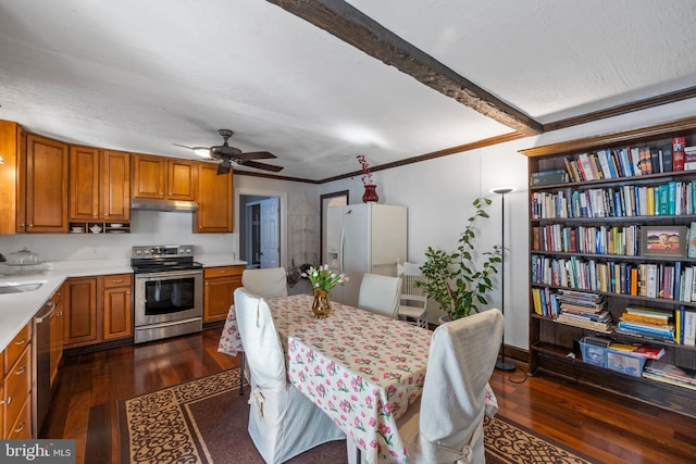 kitchen with dark wood-type flooring, ornamental molding, stainless steel appliances, and beamed ceiling