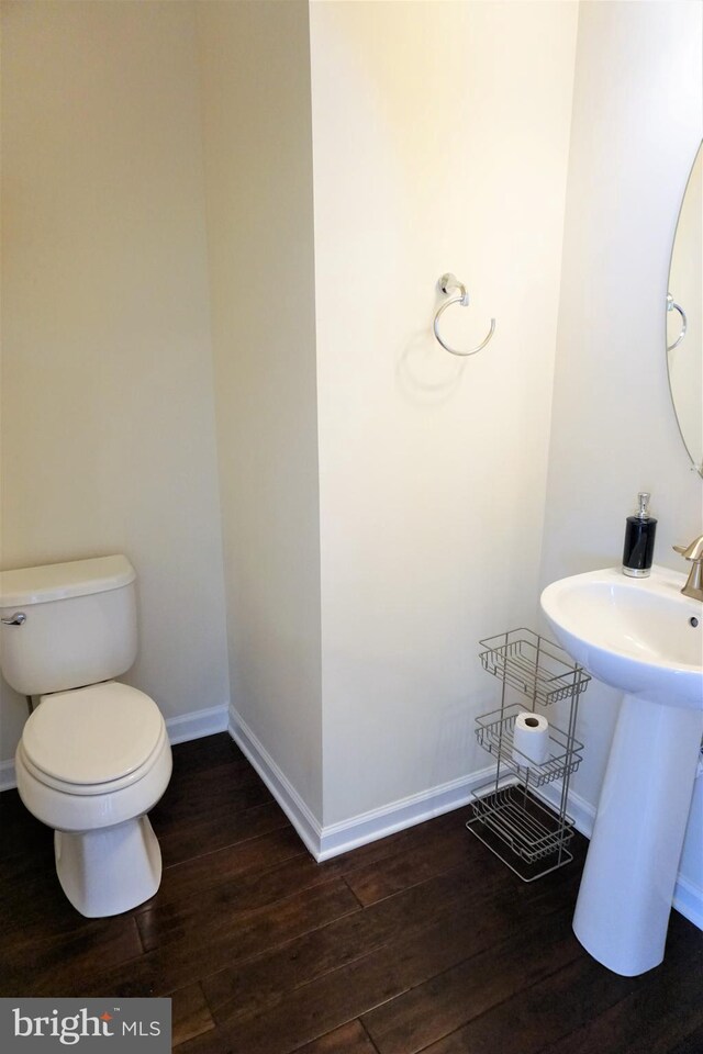 bathroom featuring sink, wood-type flooring, and toilet