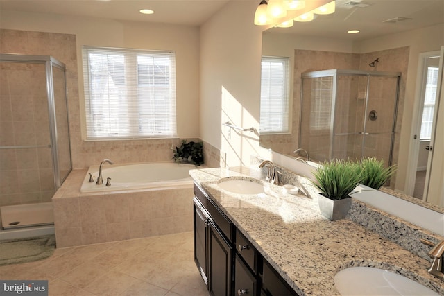 bathroom featuring independent shower and bath, tile patterned floors, and vanity