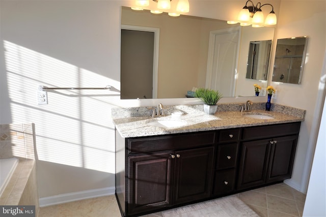 bathroom featuring a bathtub, tile patterned floors, and vanity