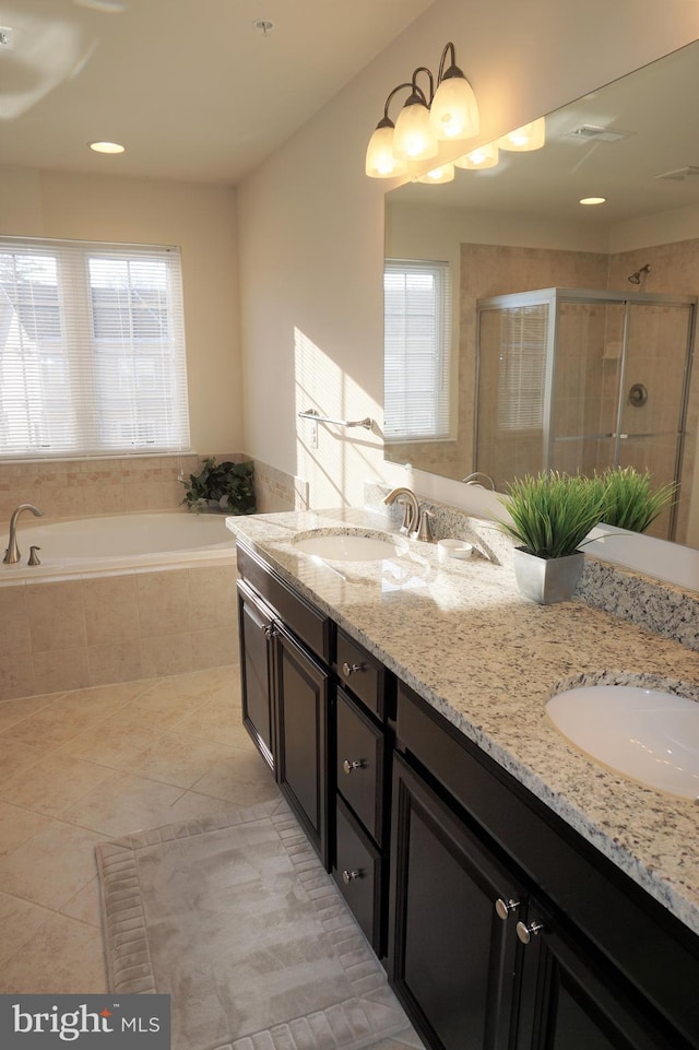 bathroom with independent shower and bath, tile patterned flooring, and vanity