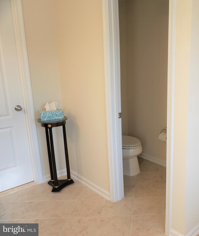 bathroom with toilet and tile patterned floors