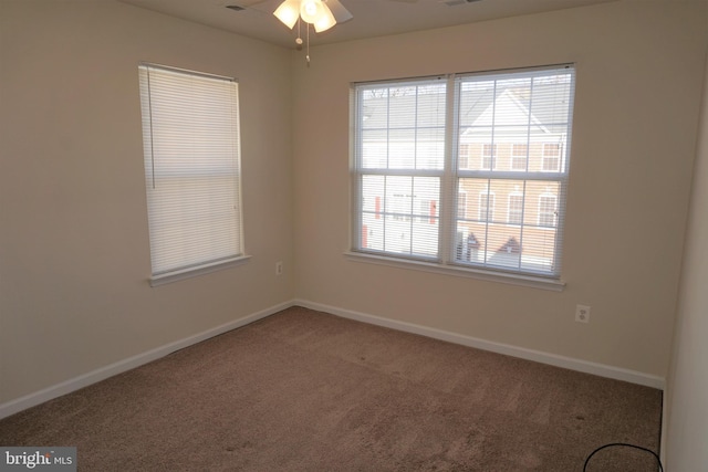 carpeted empty room featuring ceiling fan