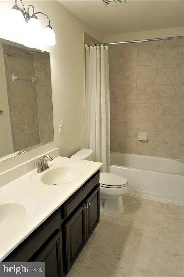 full bathroom featuring toilet, vanity, and shower / bath combination with curtain