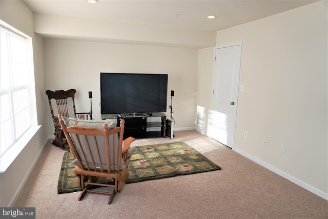 sitting room featuring light colored carpet