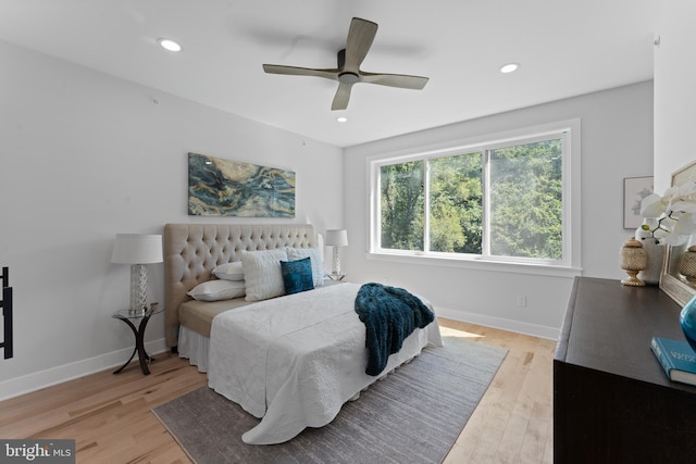 bedroom with ceiling fan and light hardwood / wood-style flooring