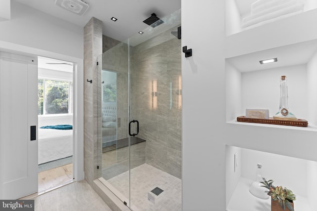 bathroom featuring an enclosed shower and tile patterned floors