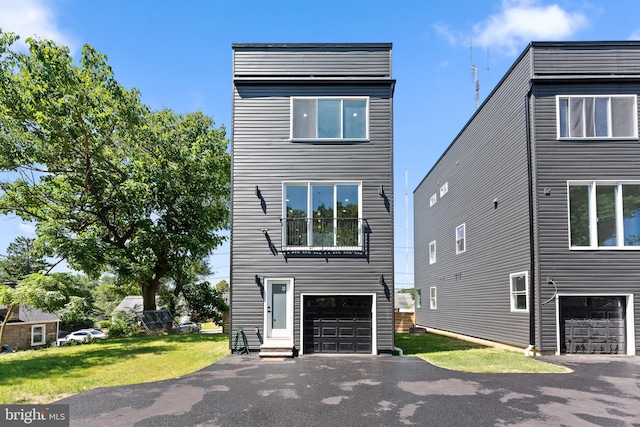 view of front facade with a front yard and a garage