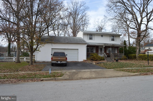 view of front facade featuring a porch, a garage, and a front lawn