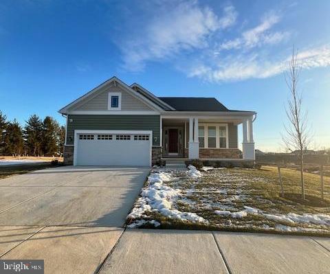 craftsman inspired home with covered porch and a garage