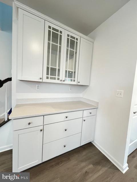 interior space with white cabinetry and dark hardwood / wood-style floors