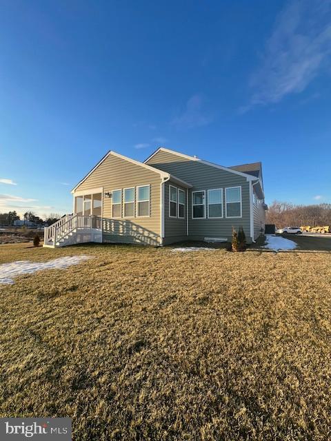 rear view of property with a yard